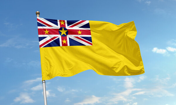 Niue flag with Union Jack and yellow field flying