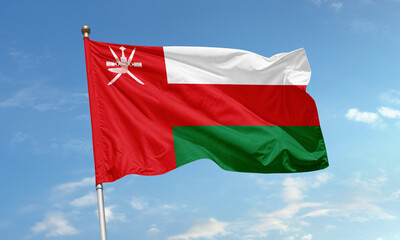 Oman national flag waving in blue sky