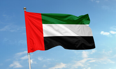 United Arab Emirates national flag waving in clear blue sky background