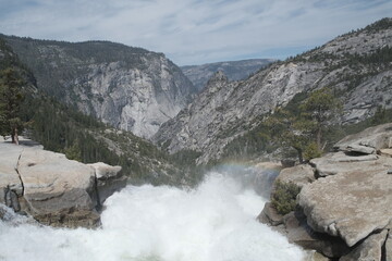 Yosemite National Park in California’s Sierra Nevada mountains luscious greenery scenery waterfall with rainbow