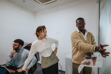 A diverse group of business employees brainstorming and discussing a project in a modern office....