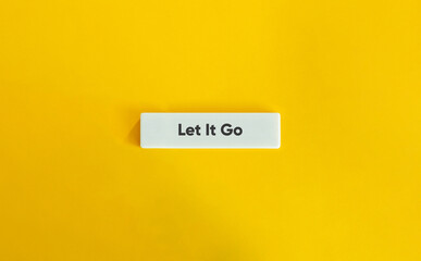 Let It Go Phrase on Letter Tile on Yellow Background – Minimalist Concept for Release, Mindfulness and Emotional Freedom