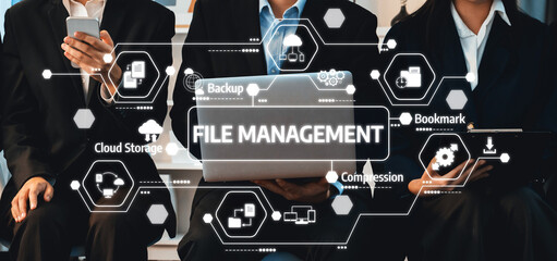 A diverse business team engages with technology to manage files effectively in a modern office. Their collaboration highlights innovation and digital solutions for productivity. Amity