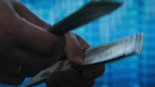 Hands holding and counting us dollar bills. Finance and investments concept. Slow Motion Effect.