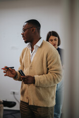 Multicultural business employees engage in a collaborative and creative meeting in an office environment, discussing ideas and strategies for a project. The setting is professional yet relaxed