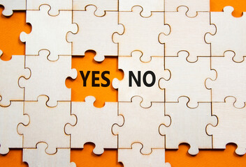 Yes or No symbol. Concept word Yes or No on wooden puzzle. Beautiful orange background. Business...