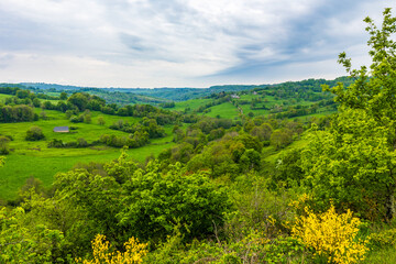 Obraz premium Panorama of the village and the verdant landscapes around Salins in the Cantal