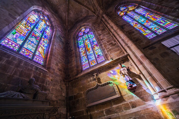 Statue and stained glass windows in Saint-Tugdual Cathedral in Tréguier, Brittany, France