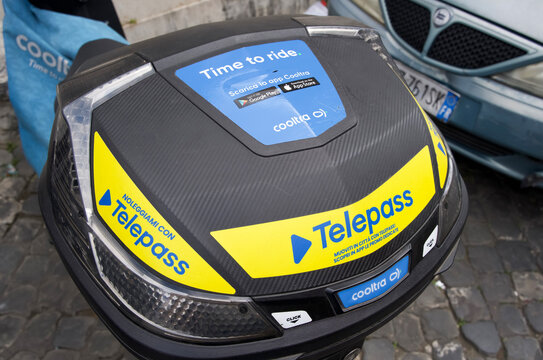 Rome, Italy - April 10, 2025: Telepass bike sharing station with branding and urban background in a bustling city environment