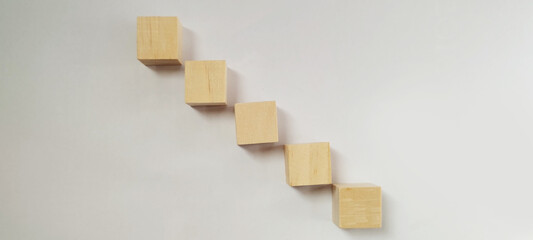 Fototapeta premium Stacked wooden blocks arrangement minimalist setting conceptual design creative display neutral background artistic perspective