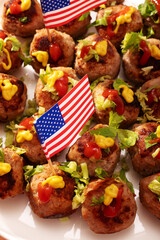 Closeup of meatballs decorated with USA flags and other patriotic dishes for 4th of July
