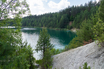 beautiful summer nature, turquoise lake surrounded by pine trees