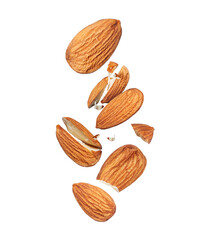 Group of whole and cracked almonds in the air close up isolated on white background