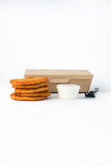 Fast food: potato pancakes in packaging on a white background. Serving for a bar, menu.