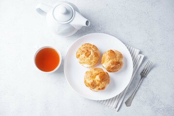 Profiteroles with cottage cheese filling in a plate