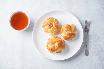Profiteroles with cottage cheese filling in a plate
