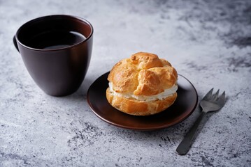 Profiteroles with cottage cheese filling in a plate