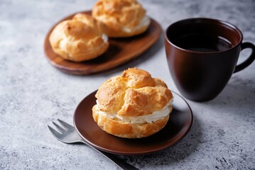 Profiteroles with cottage cheese filling in a plate