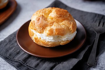Profiteroles with cottage cheese filling in a plate