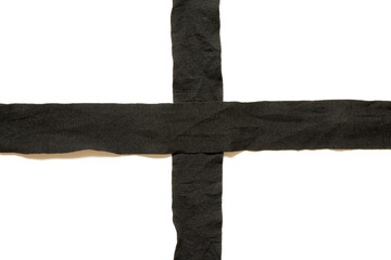 Black textile tapes in the form of a cross on a white background, boxing tapes