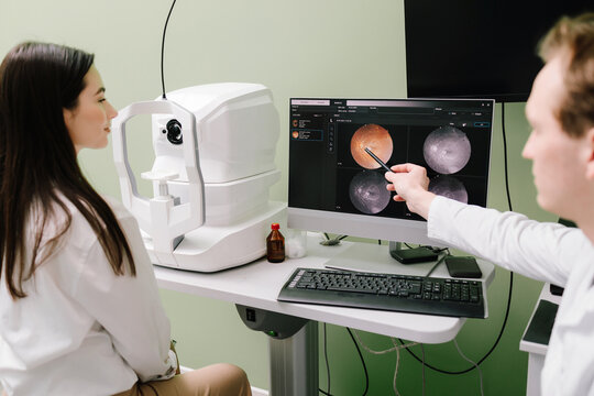 OCT eye scan imaging at an ophthalmology clinic. Girl undergoes a retina exam using optical coherence tomograph. Detailed eye image for diagnosing glaucoma, macular degeneration, and vision issues.