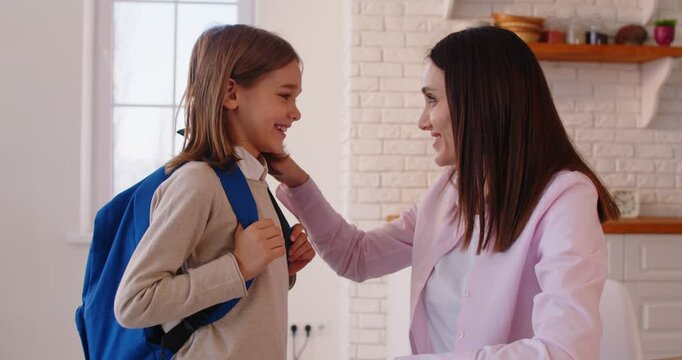 Schoolboy good morning, loving mother kissing greeting small cute student wishing to have nice day at school, saying goodbye, keep smiling, positivity supporting for productive study, pleasant time