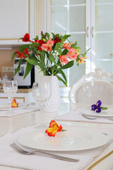 Severed table with white plates and wineglasses