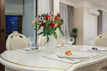 Severed table with white plates and wineglasses