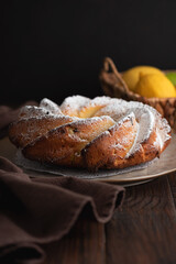 Lemon bundt cake powdered sugar on wooden table