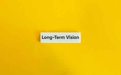 Long-Term Vision Text on Letter Tile on Yellow Background – Minimalist Strategy and Future Planning Concept