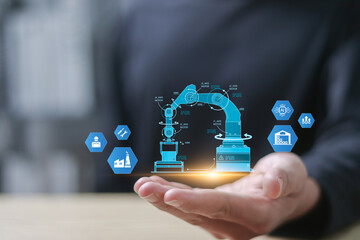 Smart industry 4.0 concept, Smart industrial revolution, automation, robot assistants, iot, cloud and big data. Businessman showing physical system on virtual screen.