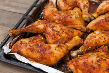 Top-down view of pub food: baked chicken drumsticks, rustic fries, sliced pickles, sauces, and beer. Cozy and casual atmosphere. Perfect for menus, blogs, or food delivery visuals