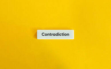 Contradiction Word on Letter Tile on Yellow Background – Minimalist Visual for Conflict, Irony, and Duality Concepts