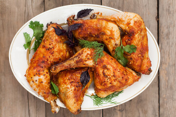 Top-down view of pub food: baked chicken drumsticks, rustic fries, sliced pickles, sauces, and beer. Cozy and casual atmosphere. Perfect for menus, blogs, or food delivery visuals