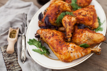 Top-down view of pub food: baked chicken drumsticks, rustic fries, sliced pickles, sauces, and beer. Cozy and casual atmosphere. Perfect for menus, blogs, or food delivery visuals