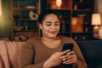 Smiling mixed race woman surfs social media on smartphone
