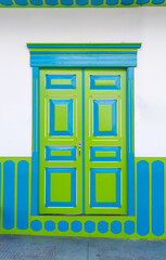 A colorful exterior facade. Vibrant Wooden Colonial Door in Traditional Style. Colombian fecade