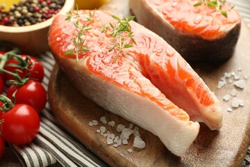 Seafood. Salmon steaks, spices and tomatoes on table, closeup