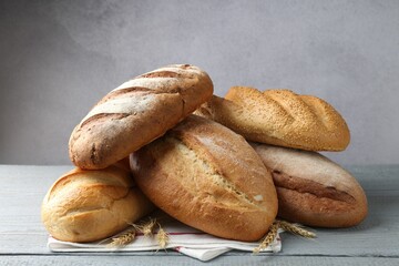 Many bread loaves on grey wooden table