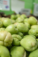 Fresh chayote squash on display at a market