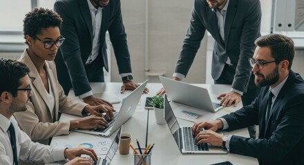 Collaborative team analyzes financial charts on laptops