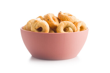 Salted crispy snack rings in bowl isolated on white background.