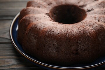 Tasty chocolate bundt cake on wooden table, closeup