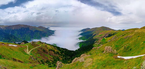 Epic panoramic view of Black Sea highlands in Turkey. Majestic sea of clouds over Karadeniz plateaus with green mountain slopes and misty valley at dawn. Breathtaking nature travel background. © Ahmetpekts