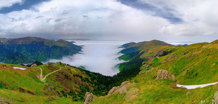 Epic panoramic view of Black Sea highlands in Turkey. Majestic sea of clouds over Karadeniz plateaus with green mountain slopes and misty valley at dawn. Breathtaking nature travel background.