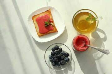 Tasty breakfast with toasts on table