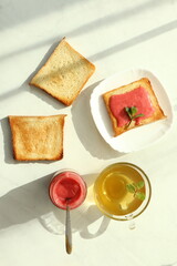 Tasty breakfast with toasts on table