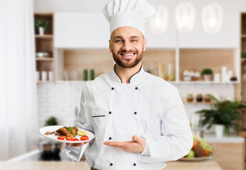 Happy Chef Man Holding Plate With Roasted Chicken Serving Dish Standing In Restaurant Kitchen. Selective Focus