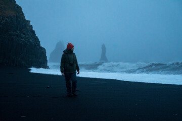 Visitors exploring Reynisfjara volcanic black beach