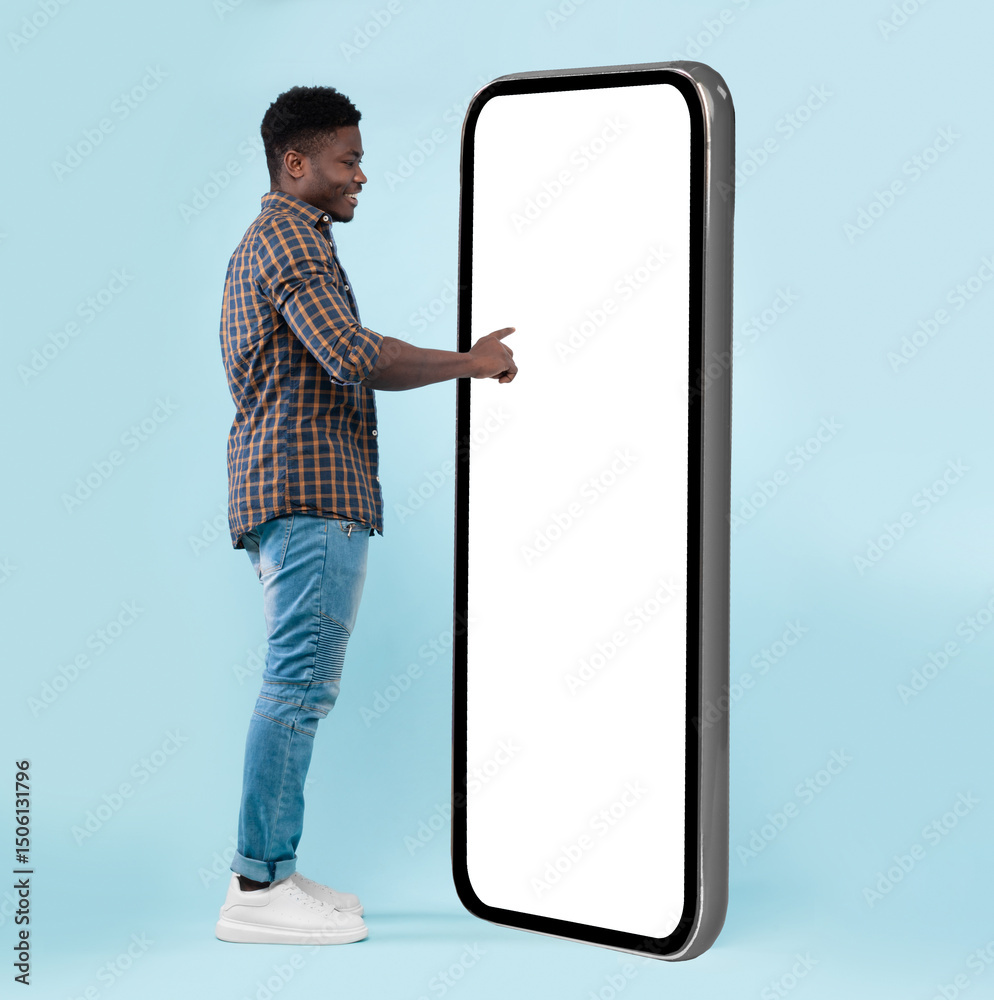 Poster full body length back view of black man using big smartphone with blank white screen touching huge d